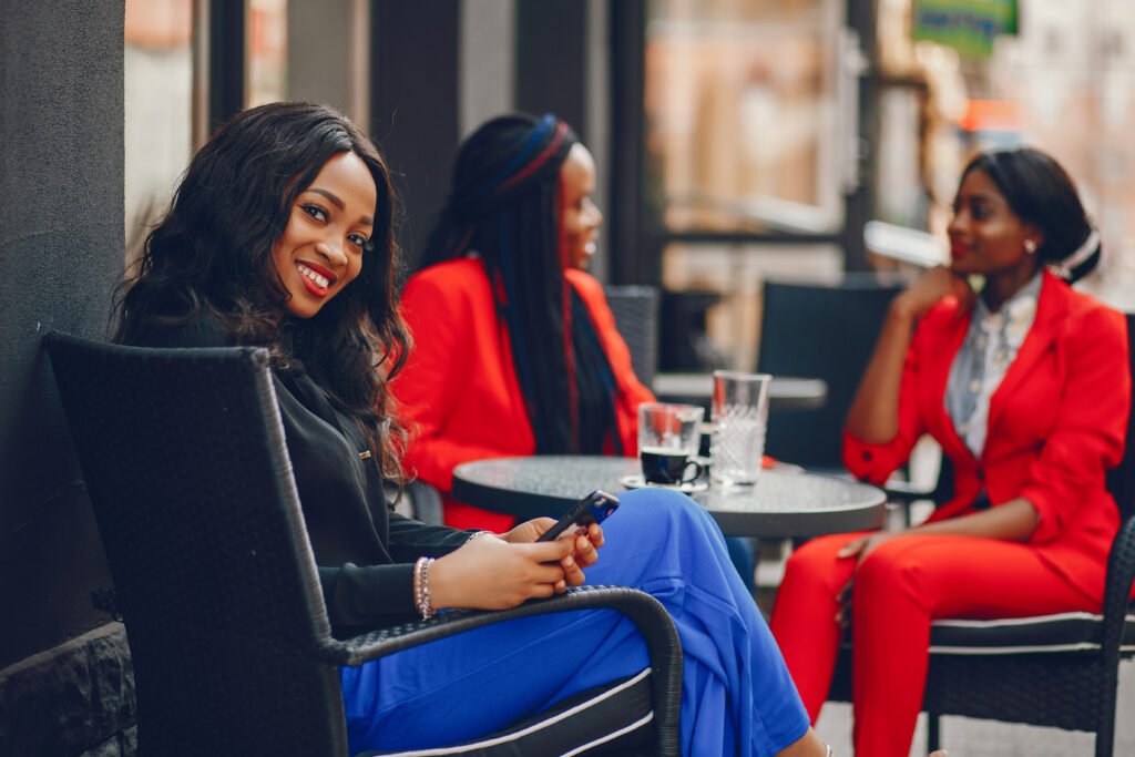 Elegant black woman standing in a summer city. Businesswoman talk at the table